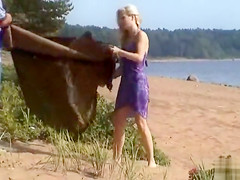 Naked blonde gives an amazing blowjob on the beach