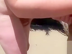 Beach handjob makes his hard dick cum