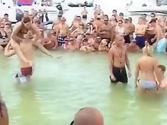 Sexy beach girls fighting each other from the shoulders of their boyfriends