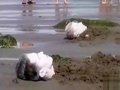 Naked performance art on the beach