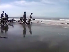 Naked performance art on the beach