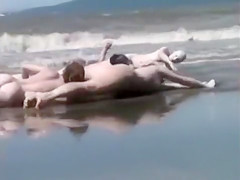 Naked performance art on the beach