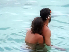 Topless GF captured when giving handjob in the water