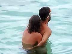 Topless GF captured when giving handjob in the water