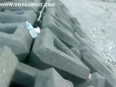 Amateur woman sits on traffic cone at the beach