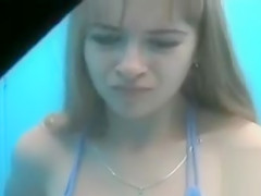 Cute teen putting on a blue bikini