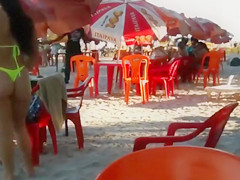 Hot Brazilian babe with big butt walks around the beach in a sensual manner