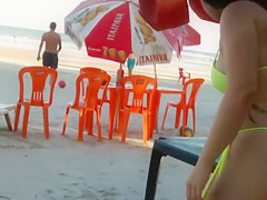 Hot Brazilian babe with big butt walks around the beach in a sensual manner