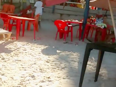 Hot Brazilian babe with big butt walks around the beach in a sensual manner
