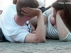 Sensual brunette looker with big tits talks with her friend on the beach