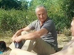 Old daddy sits with young hotties on the beach