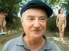 Old daddy sits with young hotties on the beach
