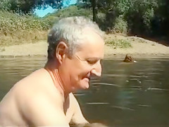 Old daddy sits with young hotties on the beach