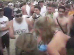 Happy girls show off their wares at a beach party