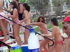 Happy girls show off their wares at a beach party