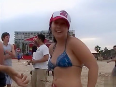 Happy girls show off their wares at a beach party