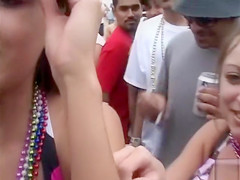 Happy girls show off their wares at a beach party