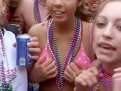 Happy girls show off their wares at a beach party