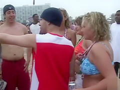 Happy girls show off their wares at a beach party
