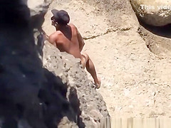 Couple spied in rocky beach having sex