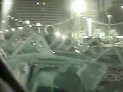 Voyeur films couples at night on a beach