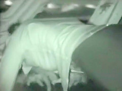 Voyeur films couples at night on a beach