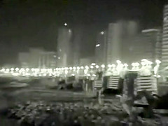 Voyeur films couples at night on a beach