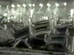 Voyeur films couples at night on a beach