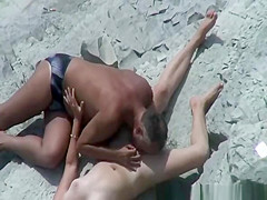 Older man licks pussy in beach