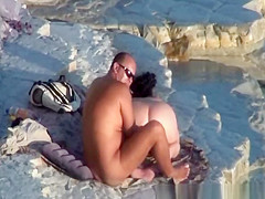 Nude couple fucking at rocky beach