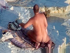 Nude couple fucking at rocky beach