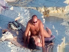 Nude couple fucking at rocky beach