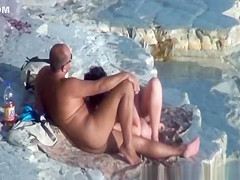 Nude couple fucking at rocky beach