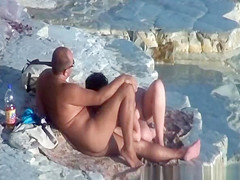 Nude couple fucking at rocky beach
