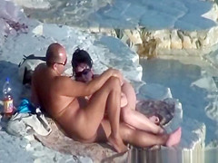 Nude couple fucking at rocky beach