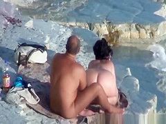 Nude couple fucking at rocky beach