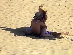Blonde girl rides her boyfriend’s dick in beach