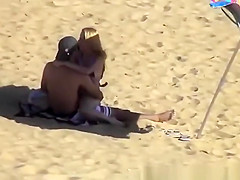 Blonde girl rides her boyfriend’s dick in beach