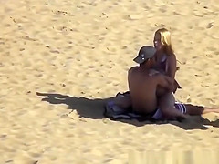 Blonde girl rides her boyfriend’s dick in beach