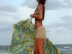 Brunette girl dressing at beach