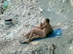 Nudist fucked hard on rocky beach