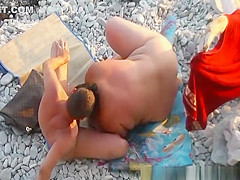 Fat woman blows her man at beach