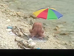 Nudist man fucking nude woman in beach