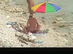 Nudist man fucking nude woman in beach