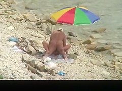 Nudist man fucking nude woman in beach