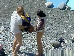 A man and his hot wife at the beach