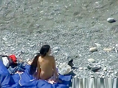 A man and his hot wife at the beach