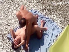 Nudist man fingers and fucks his wife in beach