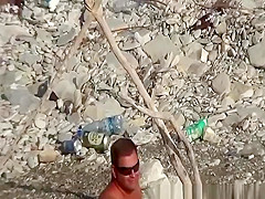 Wife strokes his man dick in beach