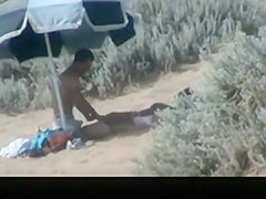 Couple spied in the beach fucking under the sun umbrella